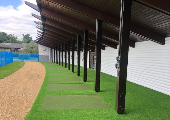 San Francisco Covered outdoor tee line with light green synthetic grass boxes inside a dark green synthetic grass strip